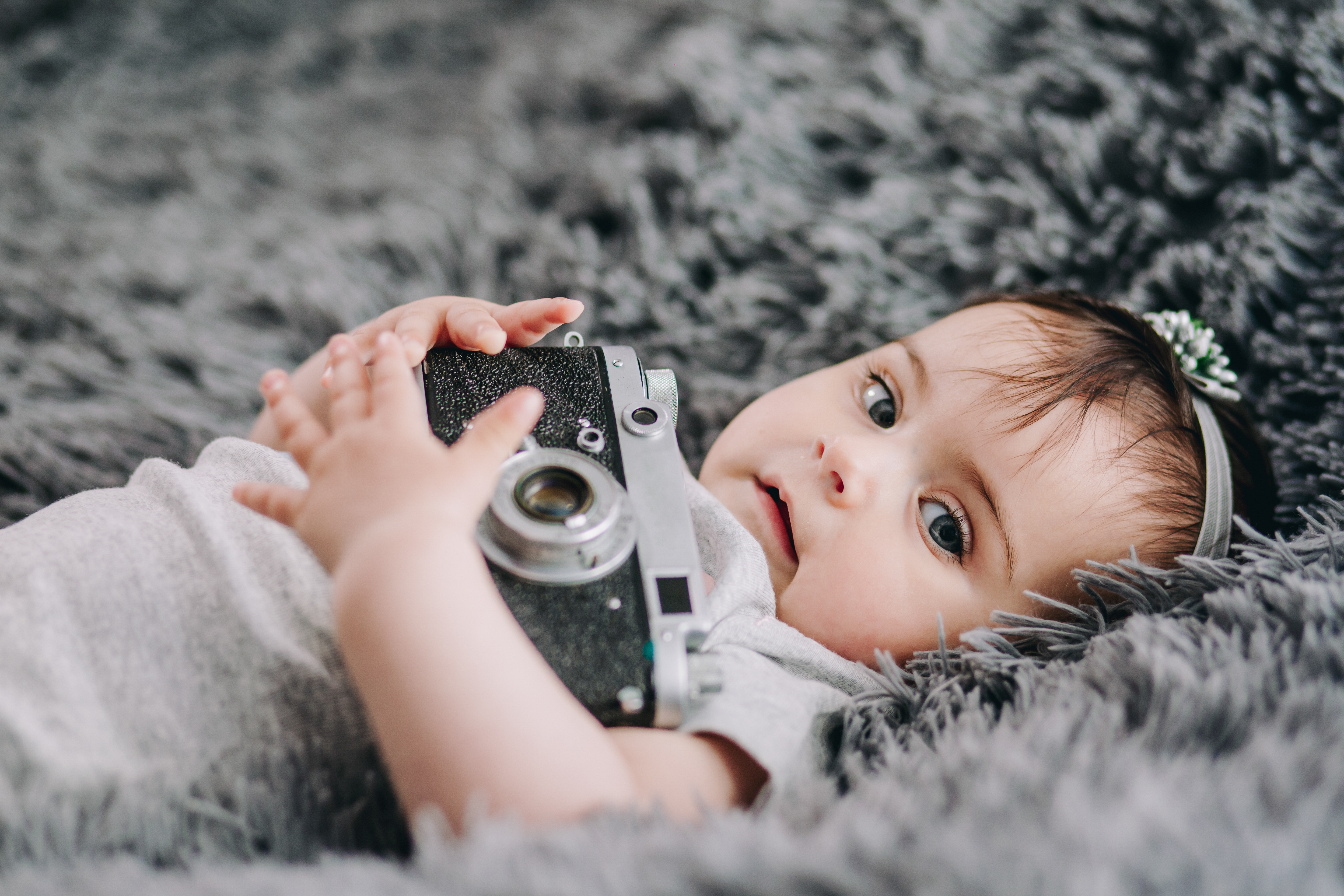 closeup-cute-adorable-baby-holding-slr-vintage-film-camera