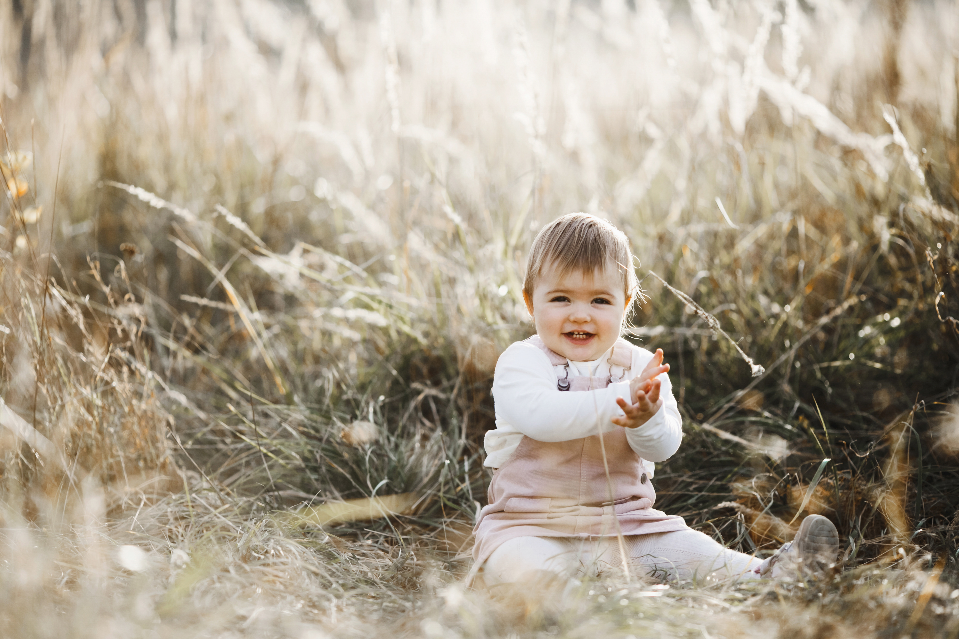 smiling-little-girl-is-sitting-lawn-sunlight